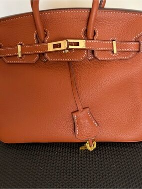 Classic style 25cm Leather Top-Handle Bag in “gold on gold”.